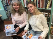 ''Волшебный декабрь''. Родители читателей рассматривают творческую памятную книгу о работе Школы снеговиков. Библиотека им. В. Дубинина. 7 декабря 2025 года